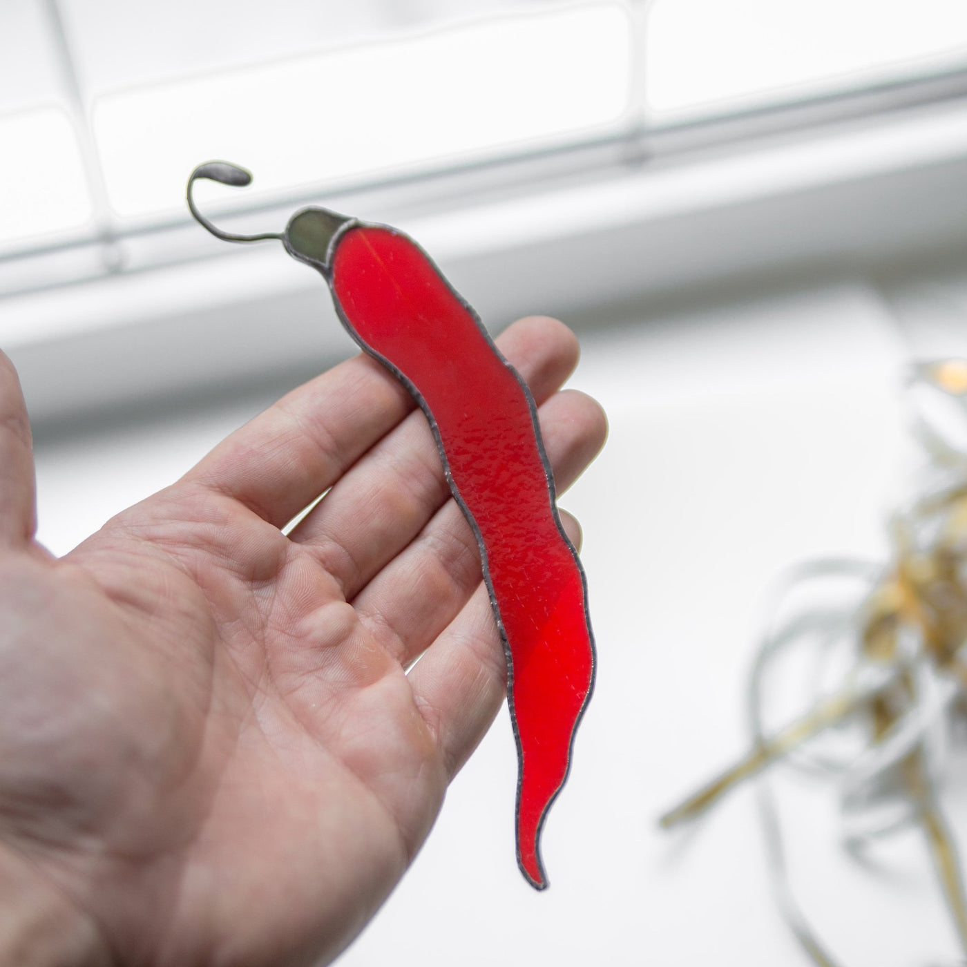 Suncatcher of a stained glass chilli pepper