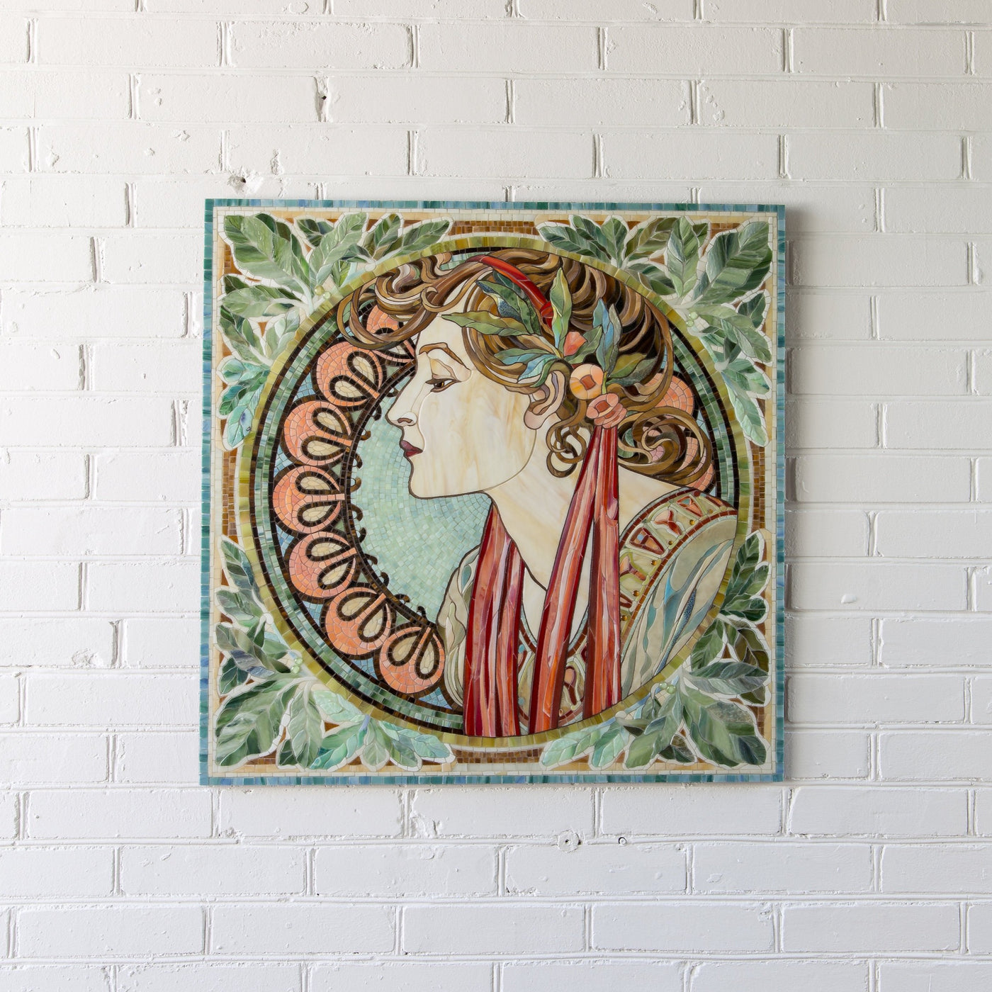 Mosaic of stained glass depicting woman in laurel by Alphonse Mucha for wall decor