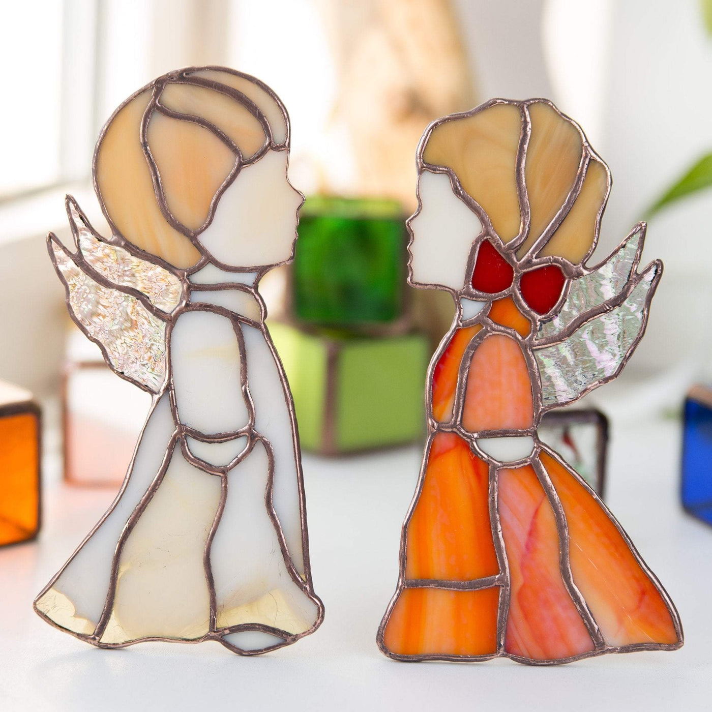 Stained glass beige angel boy and red angel girl window hangings