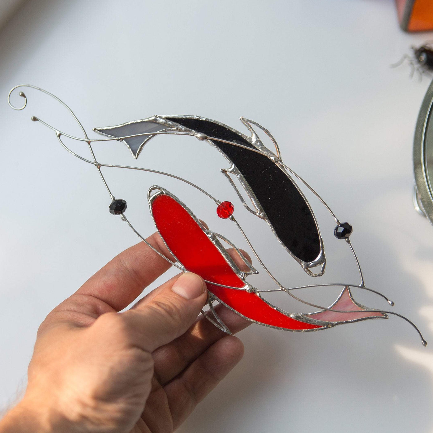 Suncatcher of stained glass yin yang koi fishes of red and black colours