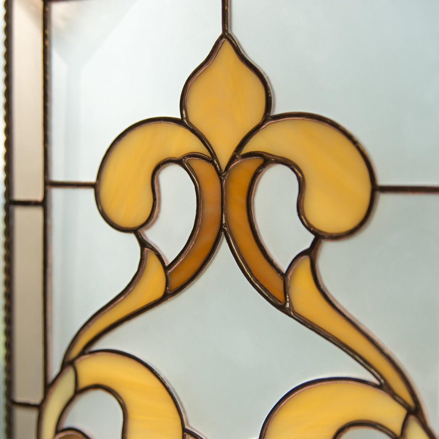 Zoomed stained glass panel with classic ornament ringlets