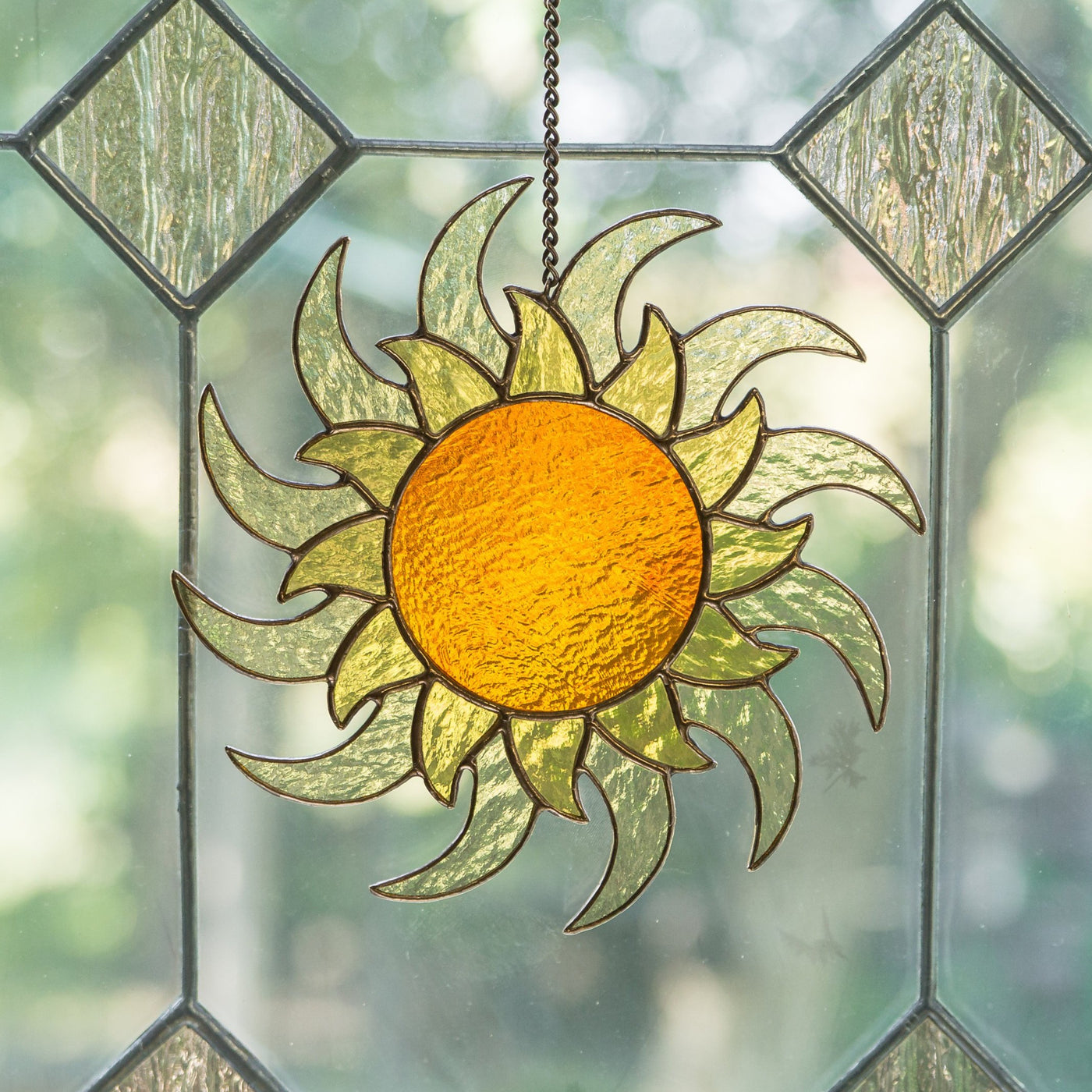 Window hanging of a stained glass shining sun