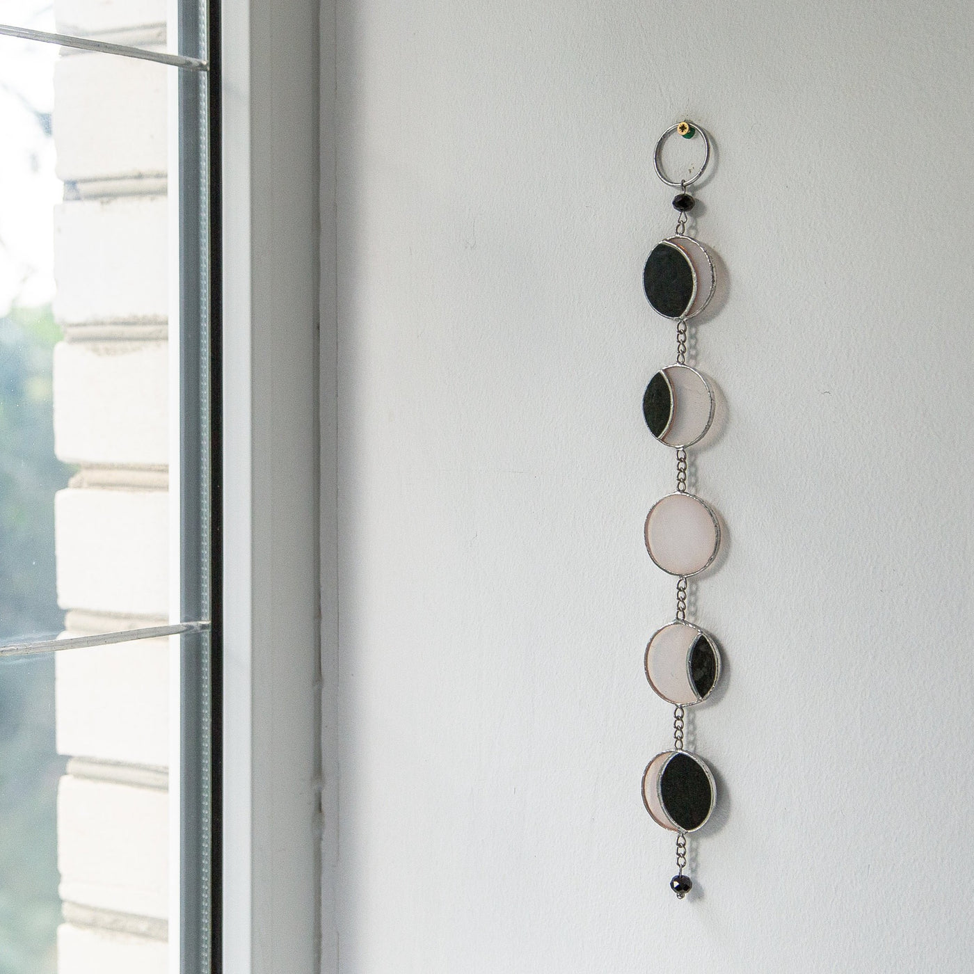 Stained glass moon phases suncatcher as a wall hanging