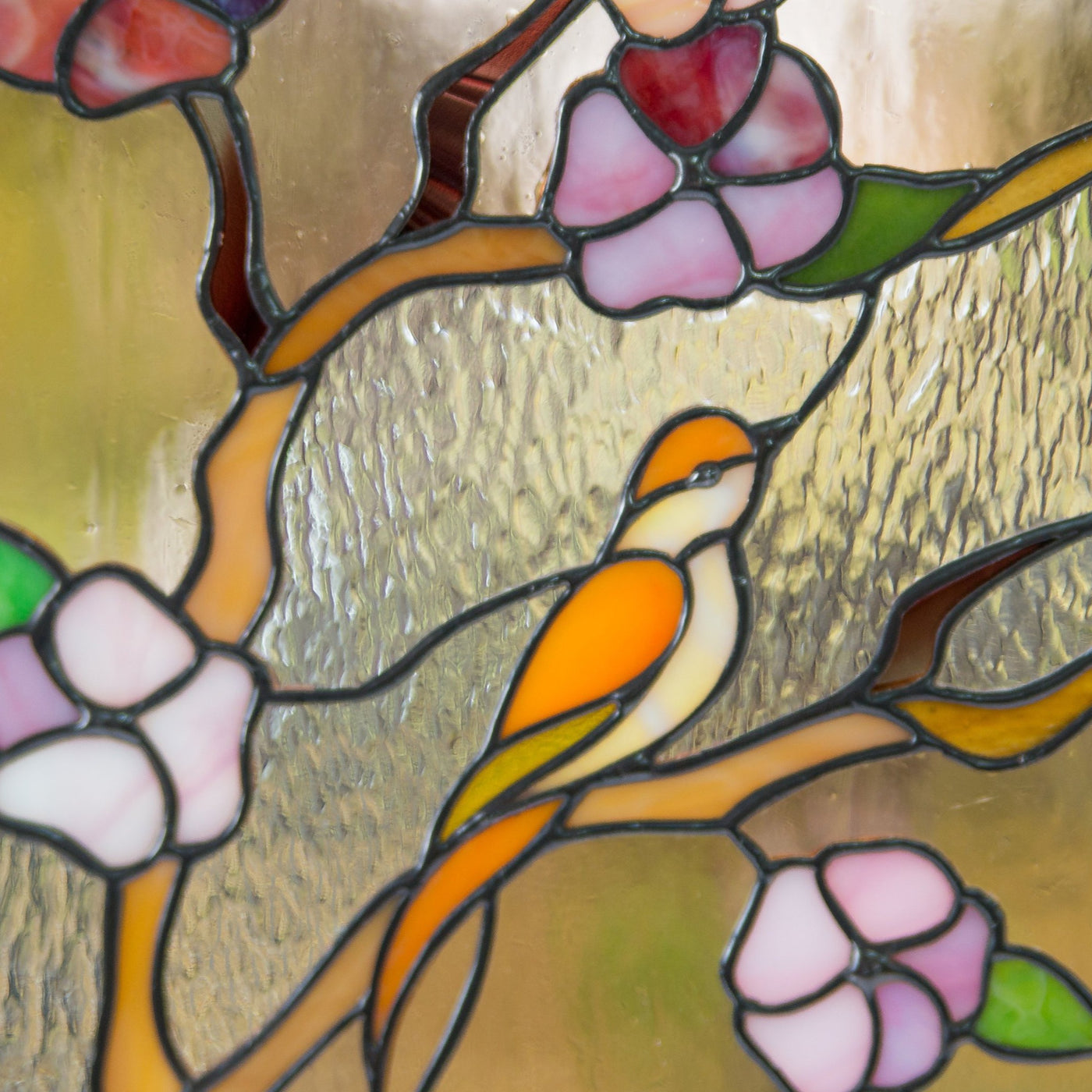 Zoomed stained glass cherry blossom panel with bird depicted on it