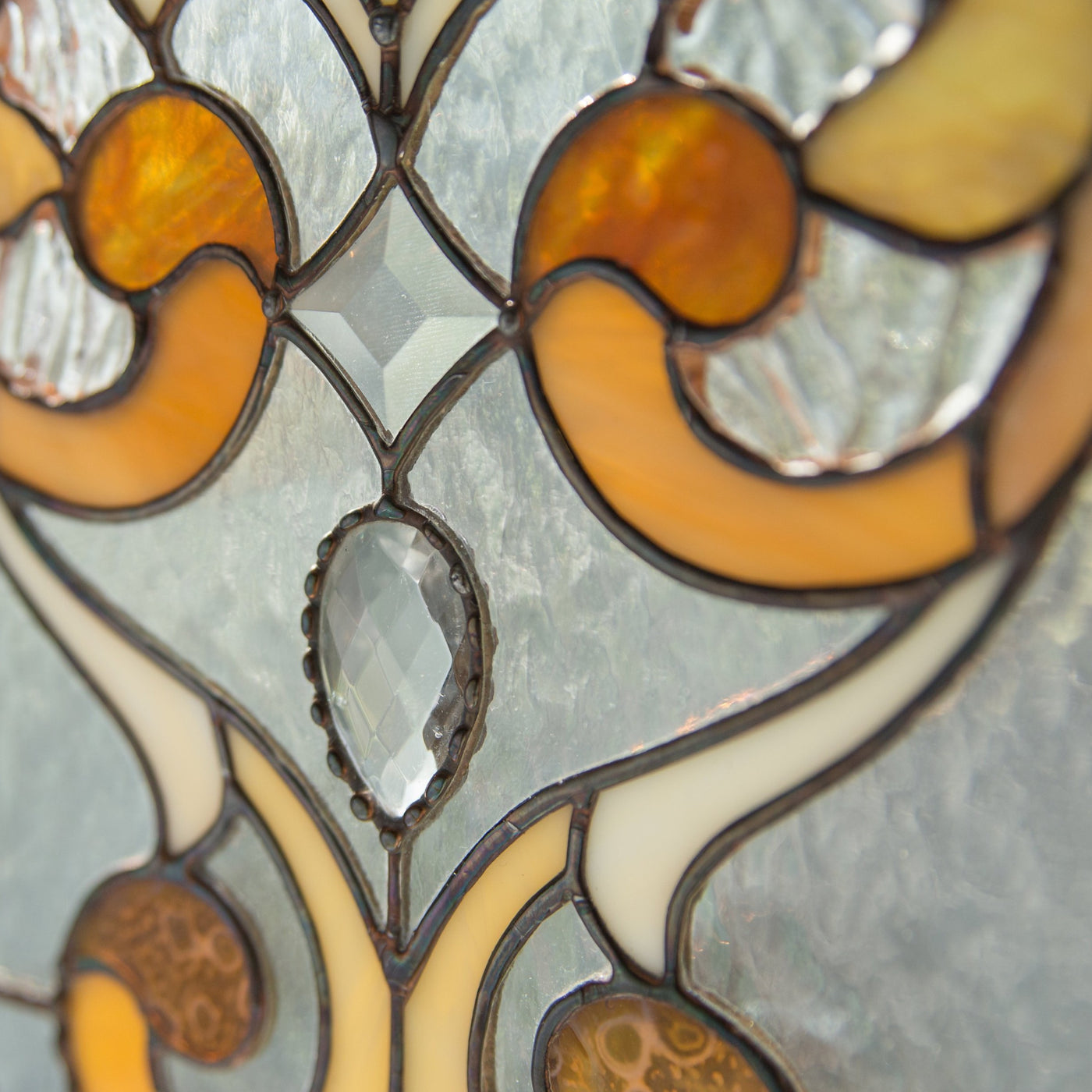 Zoomed stained glass beveled insert and ringlets on the panel