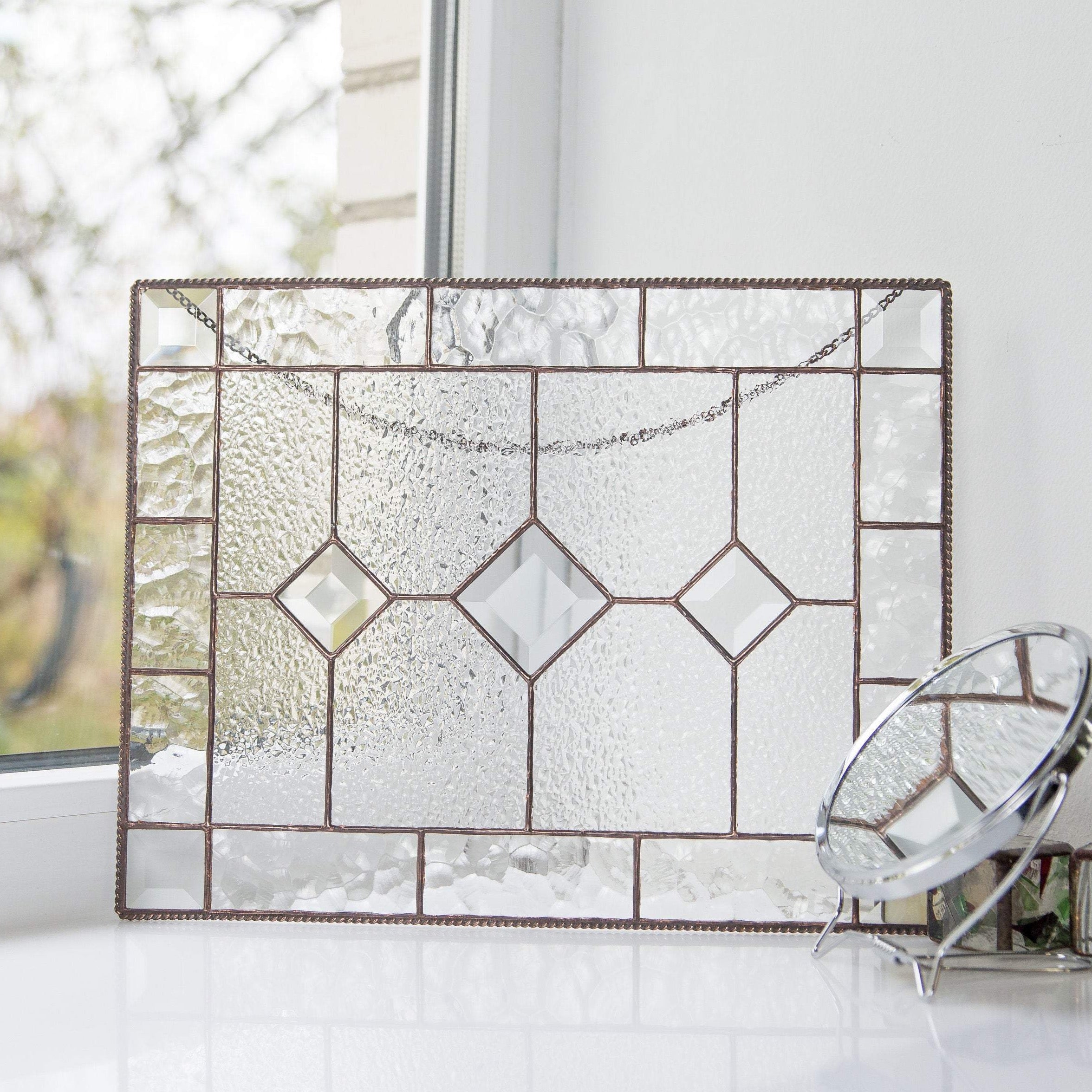 Clear panel of stained glass with three beveled inserts