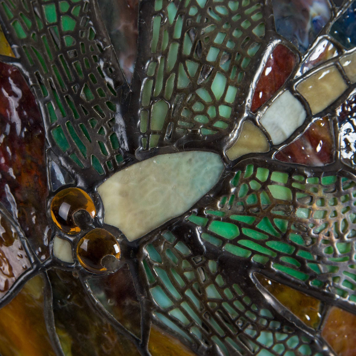 Zoomed stained glass dragonfly on mosaic dragonfly lamp