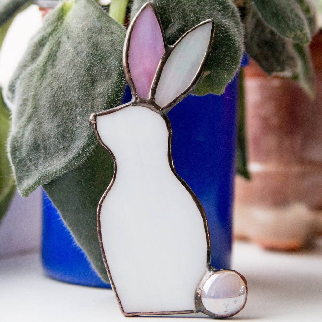 Zoomed stained glass white bunny with one pink ear window hanging