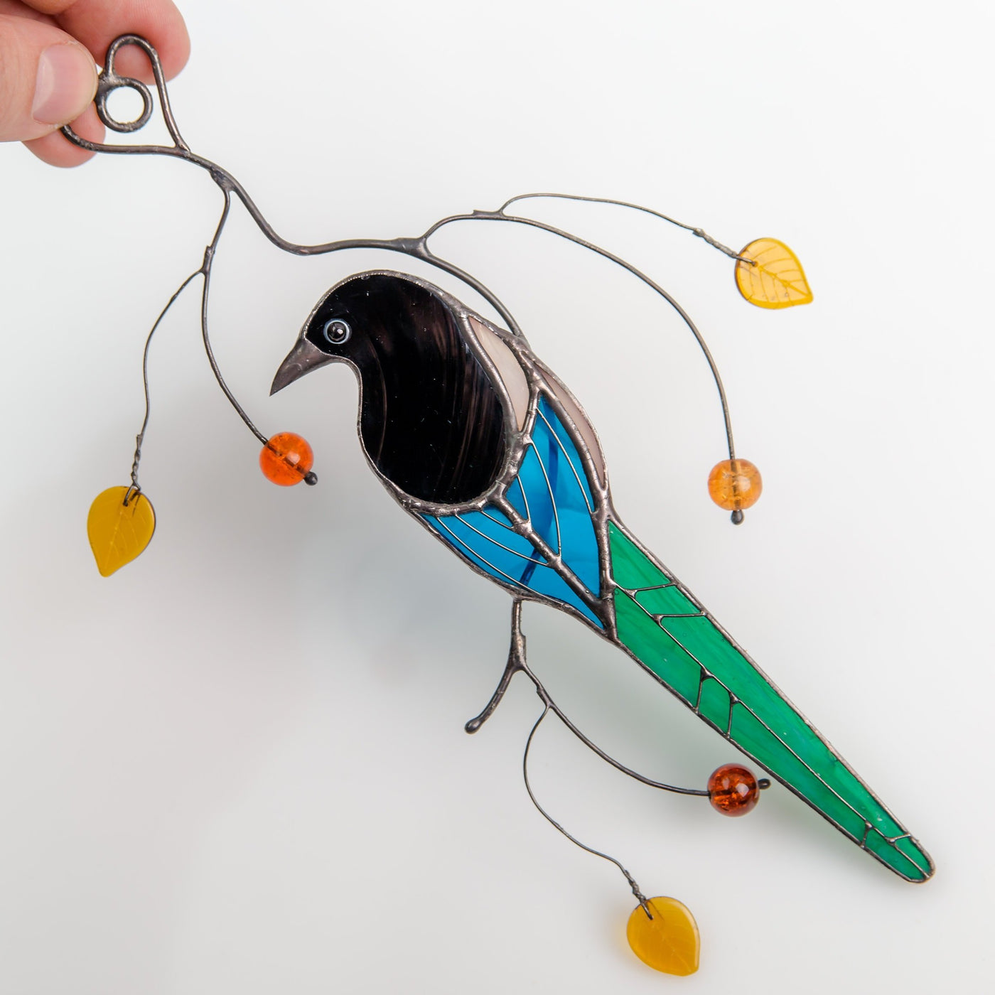 Stained glass suncatcher of a magpie back view