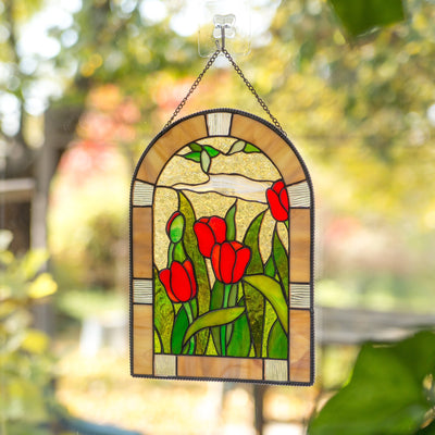 Window hanging of stained glass depicting red tulips with leaves