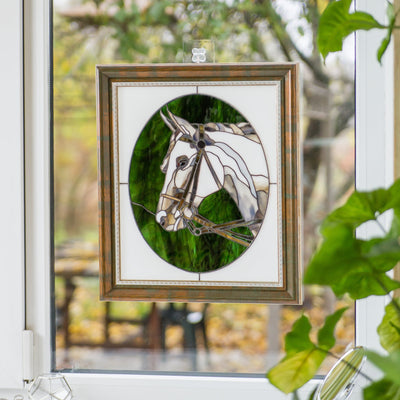 Stained glass horse portrait in a green oval and white background framed panel