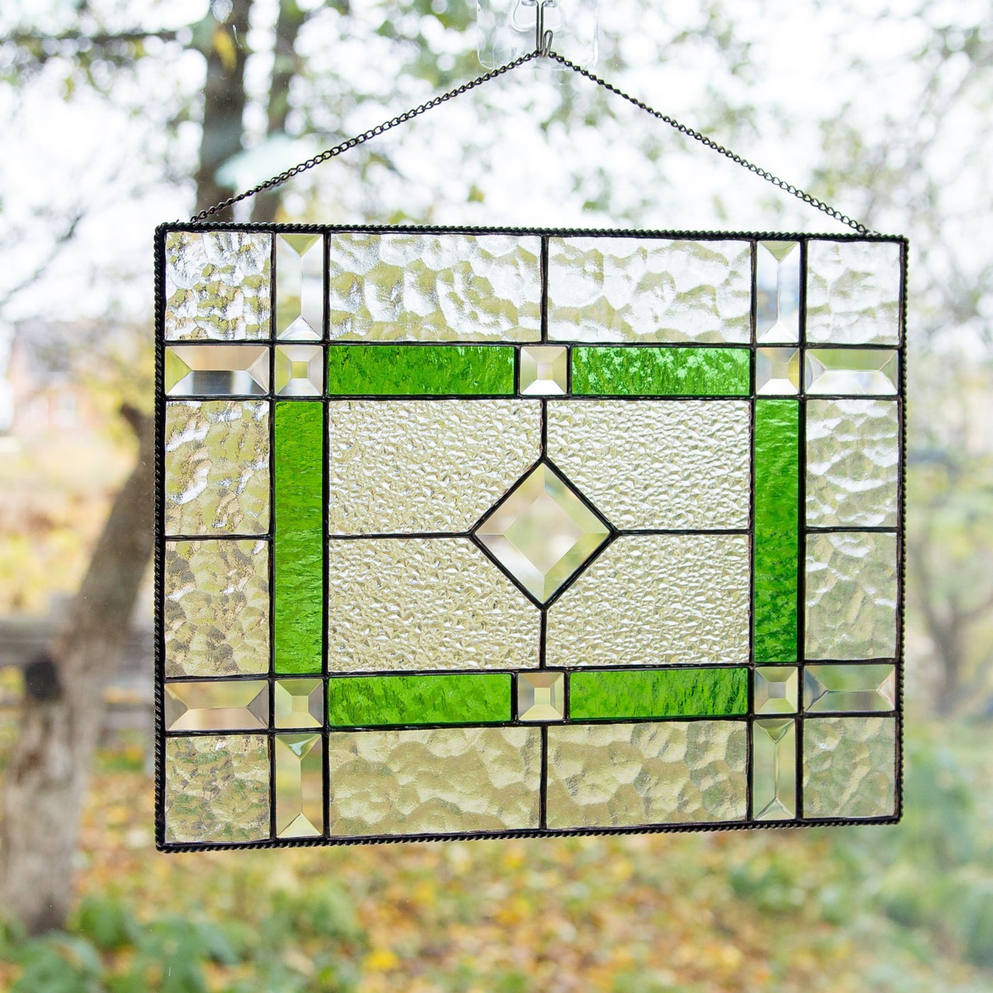 Stained glass clear panel with green and beveled inserts 