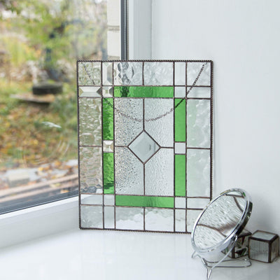 Clear and green panel of stained glass with beveled inserts