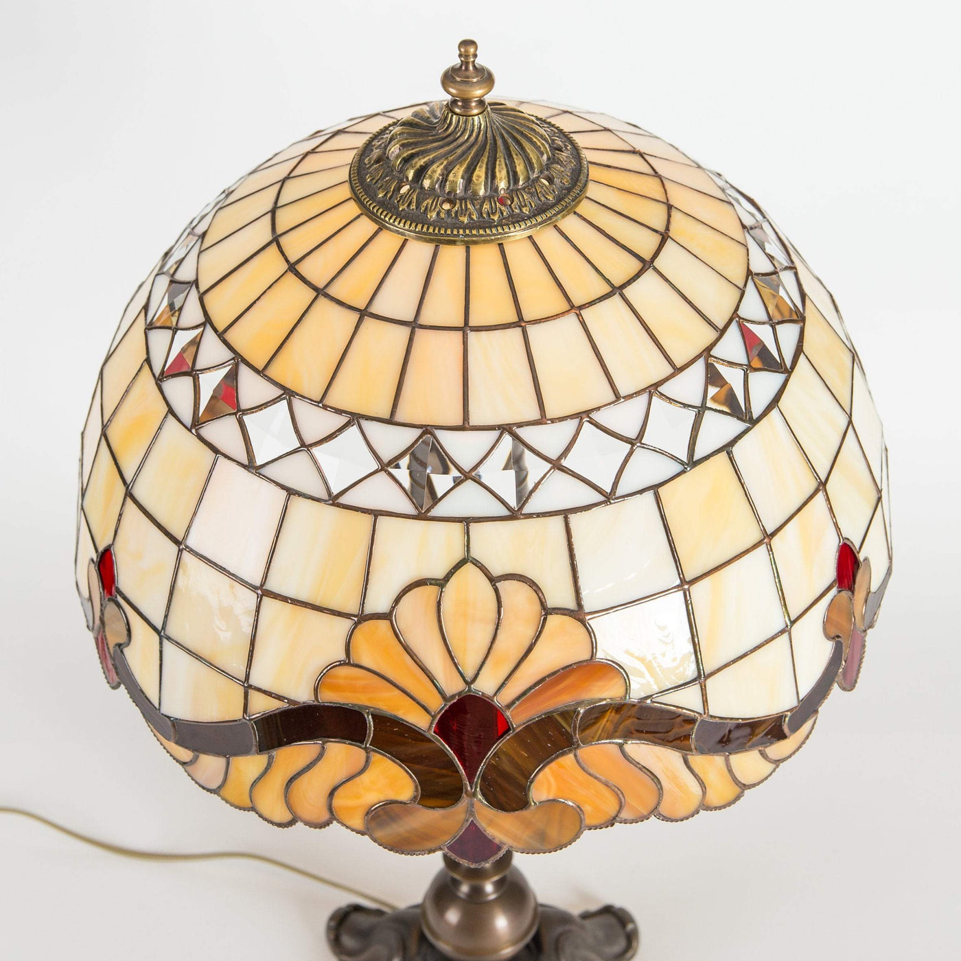 Top view of stained glass beige Tiffany lampshade with red inserted markings