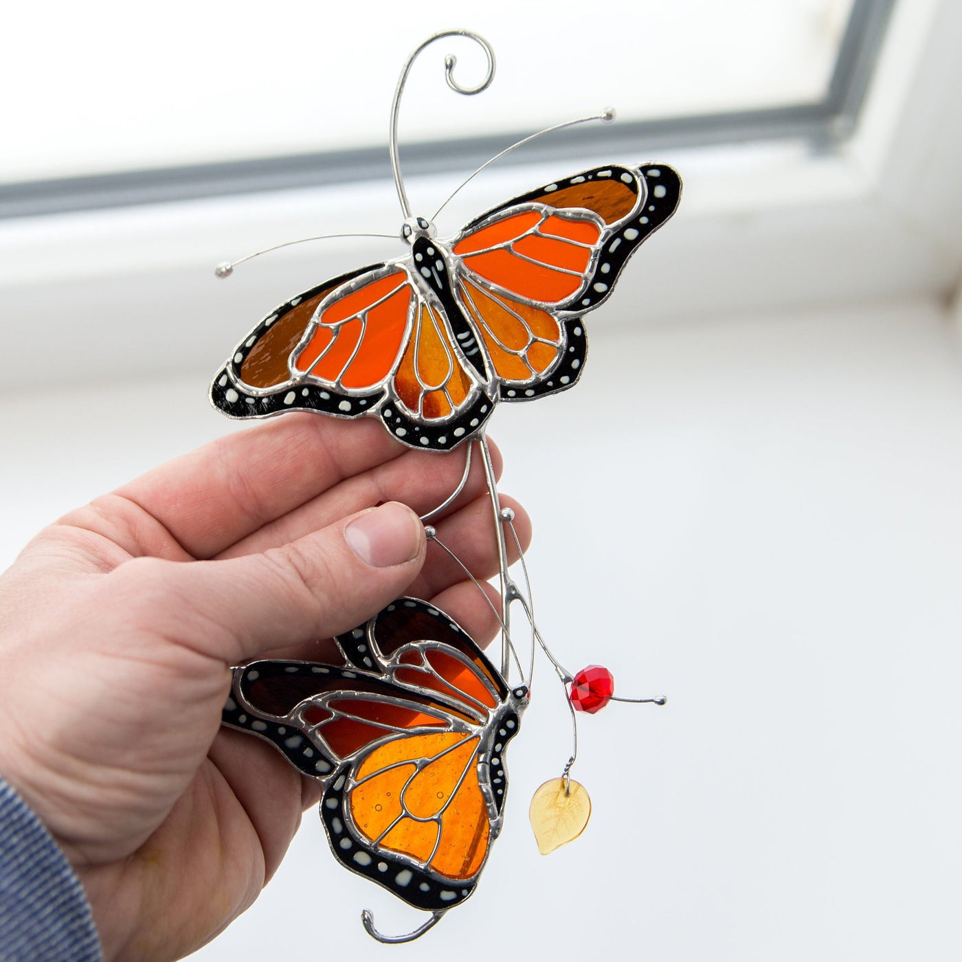 Window hanging of stained glass orange monarch butterflies