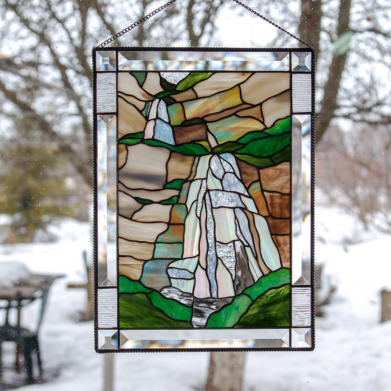 Stained glass panel depicting Bridal Veil Falls in Utah with its cliffs 