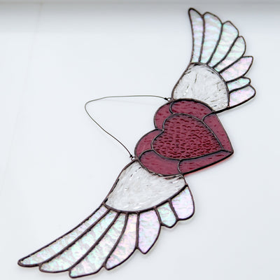 Suncatcher of a stained glass iridescent-winged heart