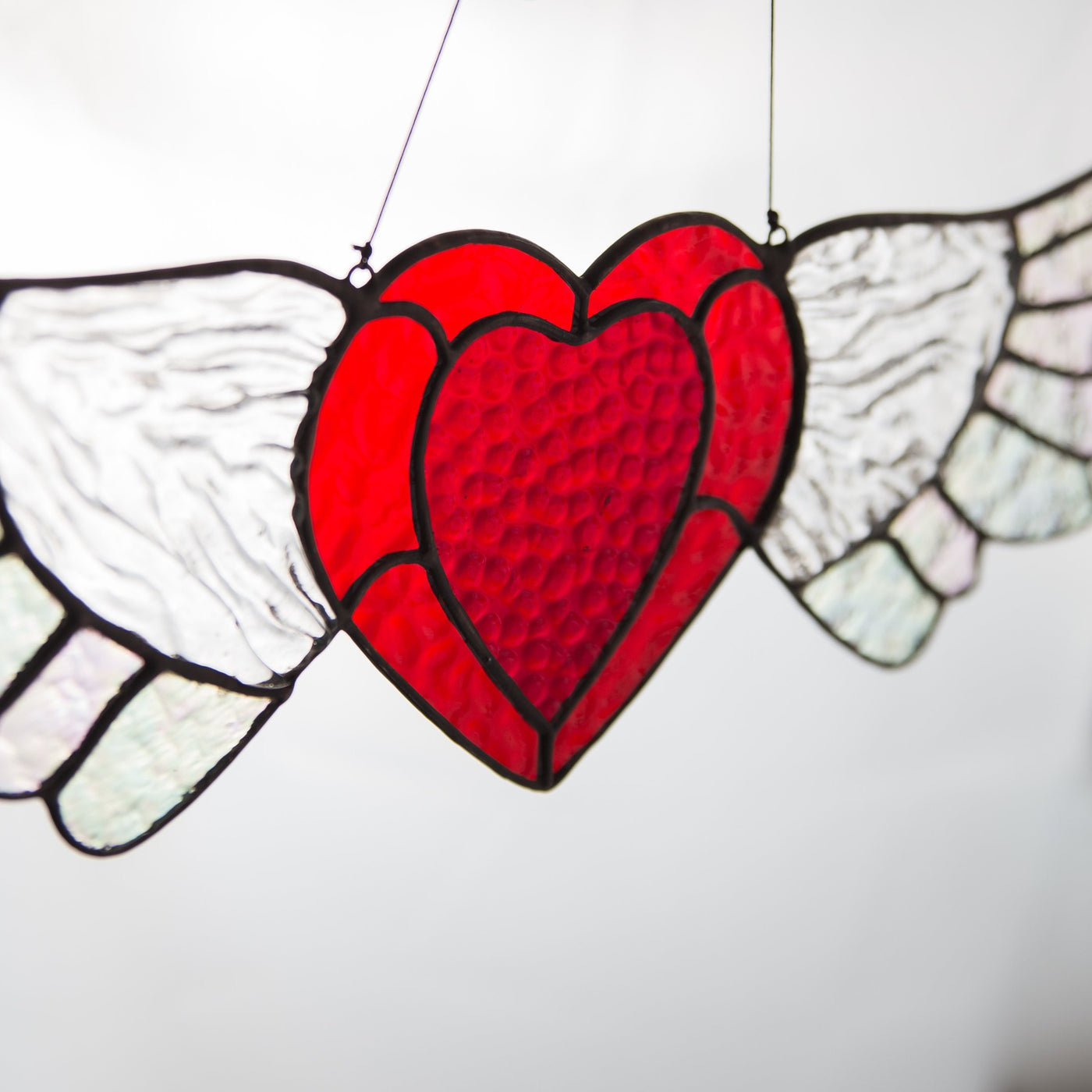 Zoomed stained glass iridescent-winged heart suncatcher for window