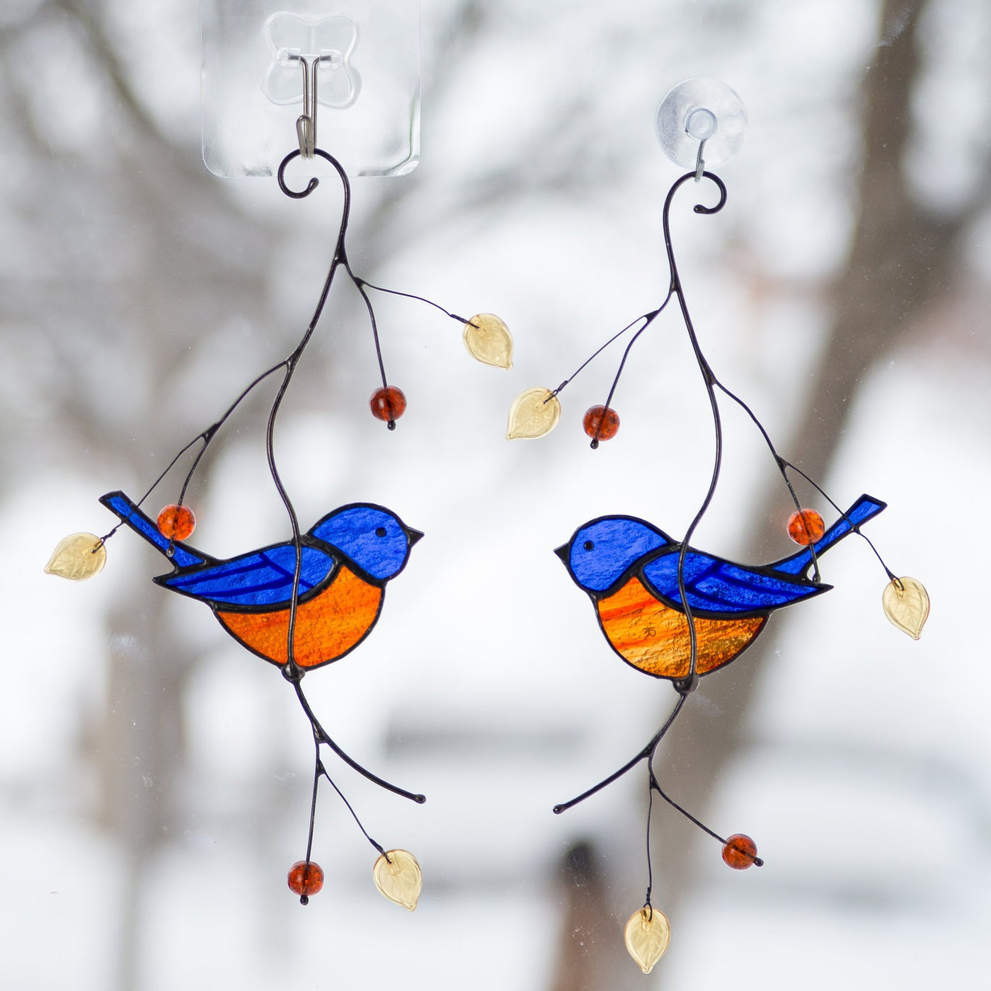 Stained glass bluebirds sitting on the branch suncatcher