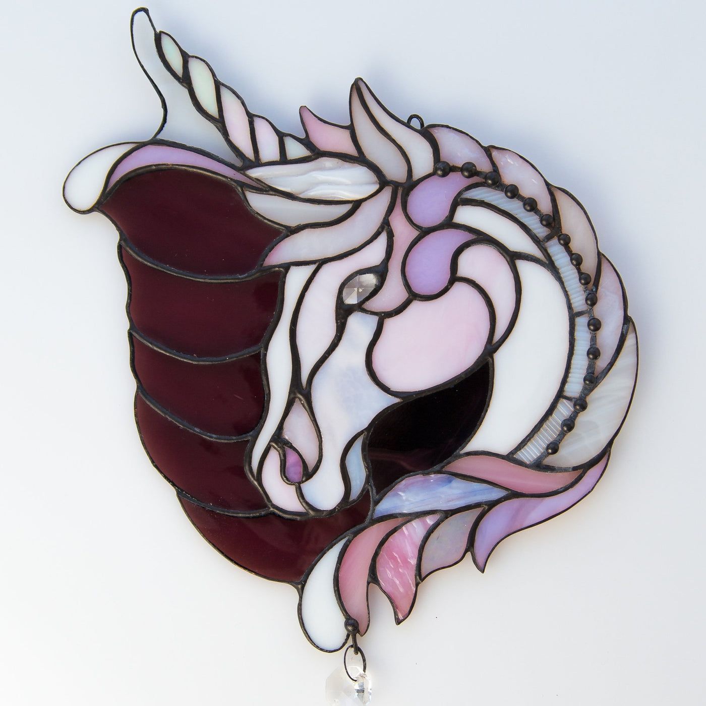 Suncatcher of a stained glass pink and purple unicorn 
