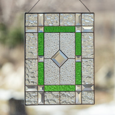 Stained glass panel of green colour with beveled inserts