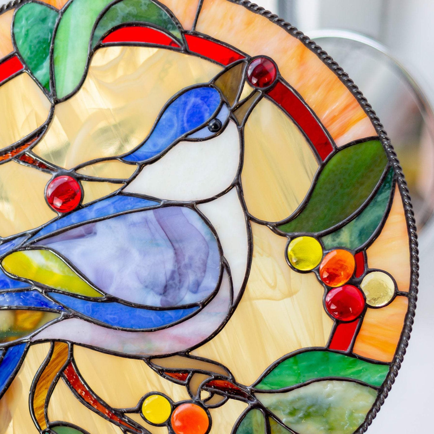 Zoomed stained glass blue jay bird round panel