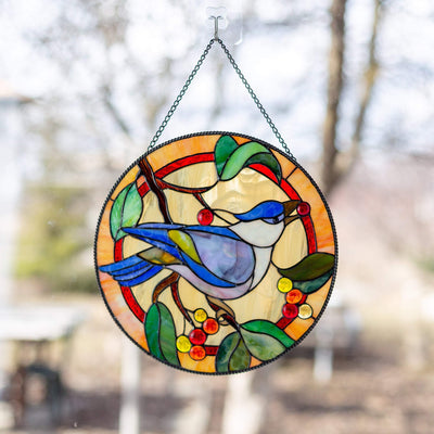 Blue jay bird sitting on the brand with the berries and leaves stained glass panel 