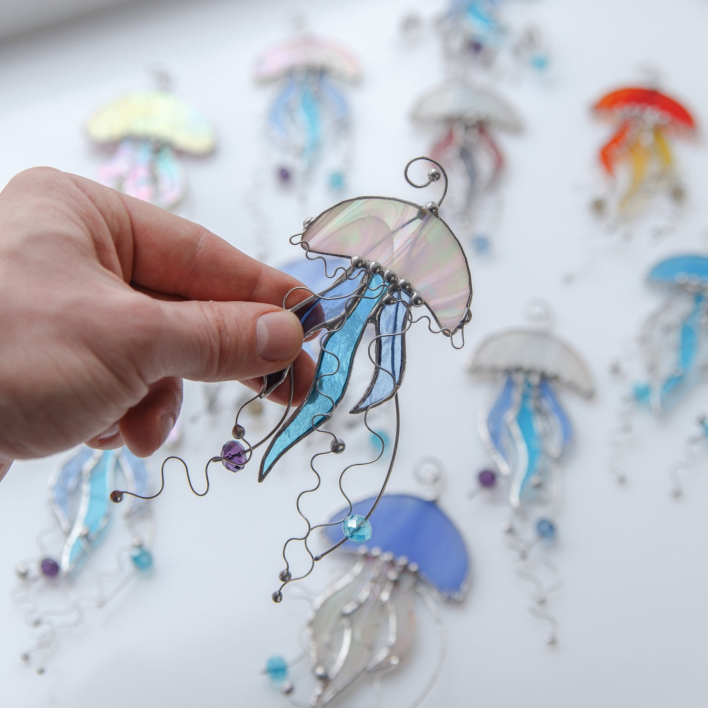 Iridescent jellyfish with blue tentacles stained glass window hanging