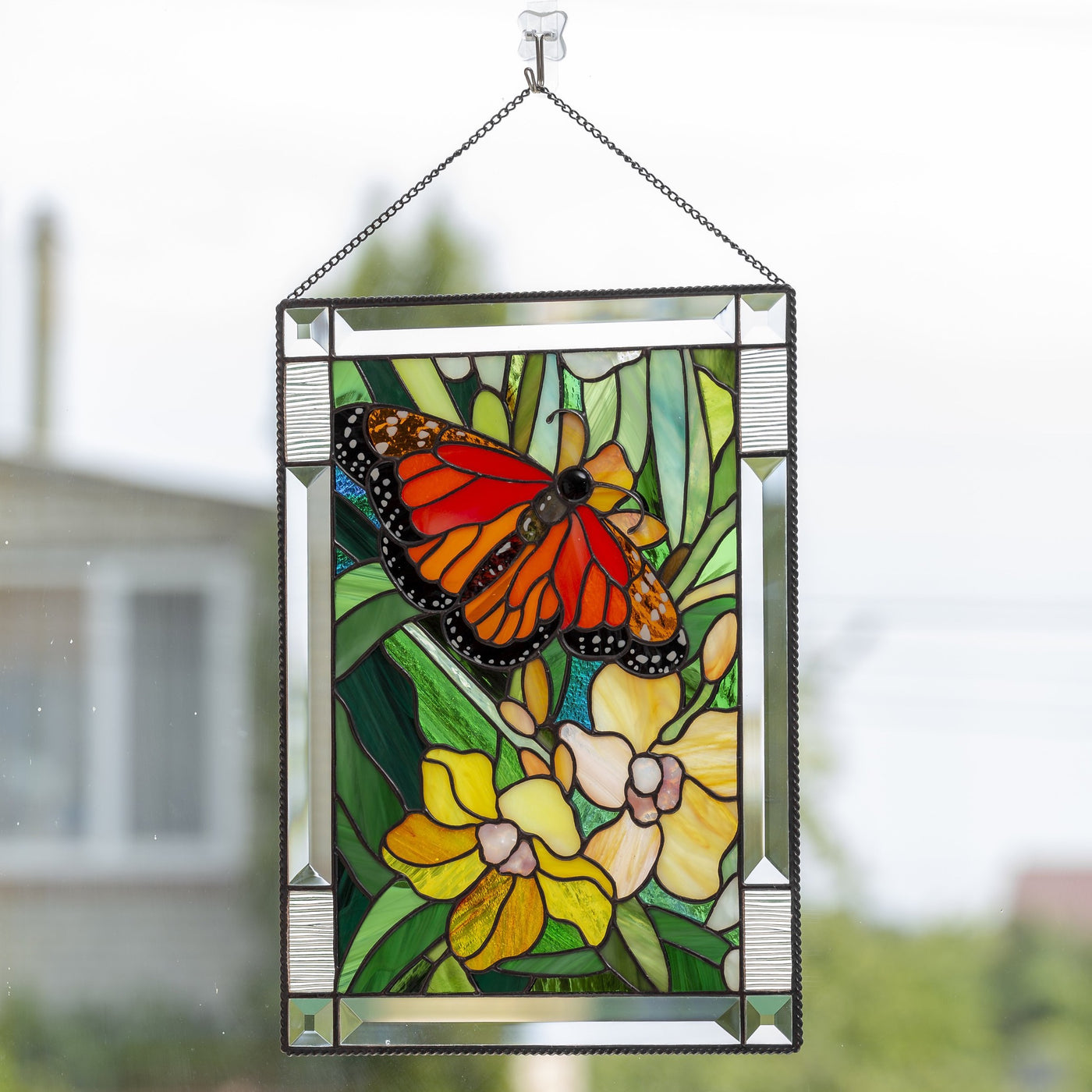 Stained glass panel depicting monarch butterfly with orchids for window 