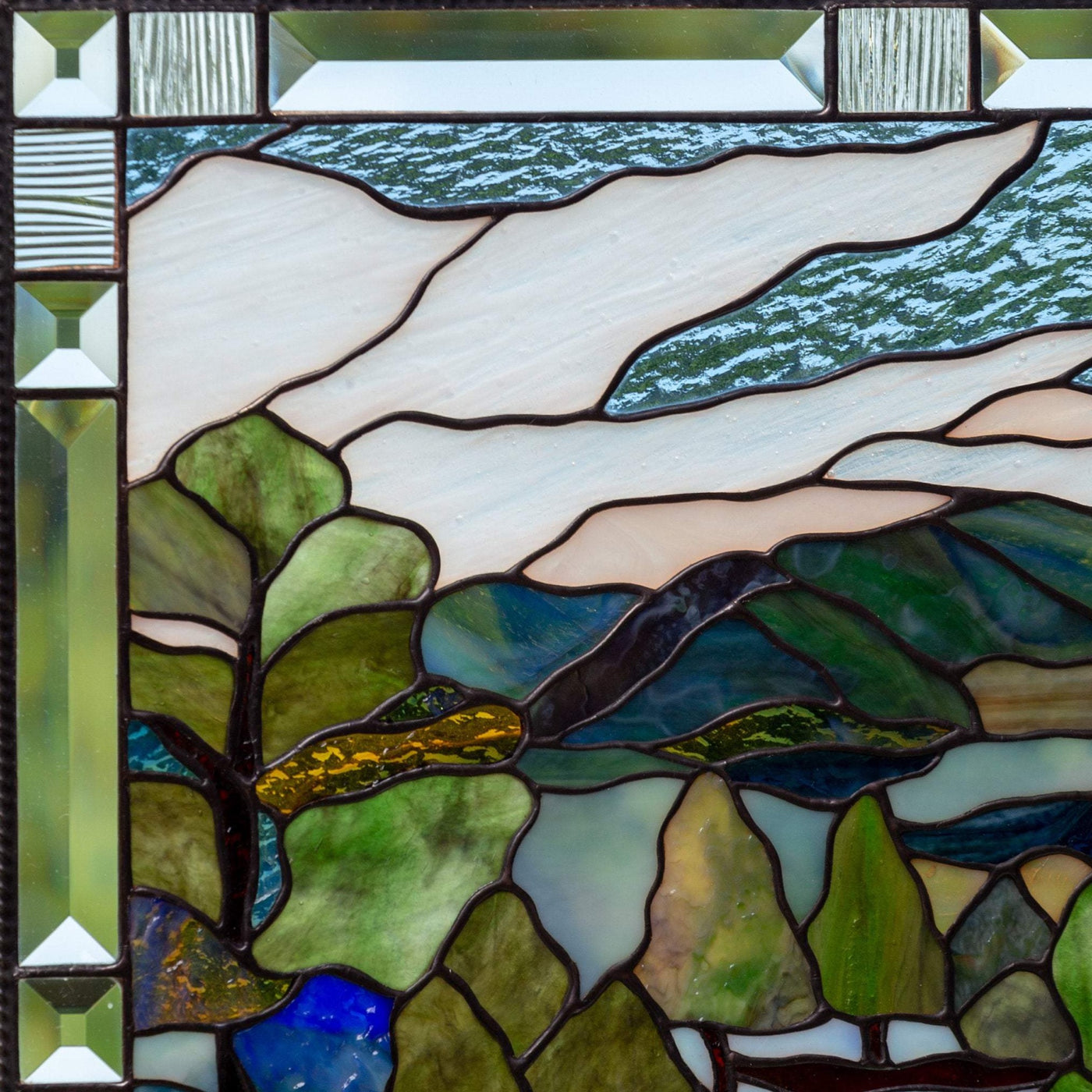 Zoomed stained glass panel depicting Estes Park