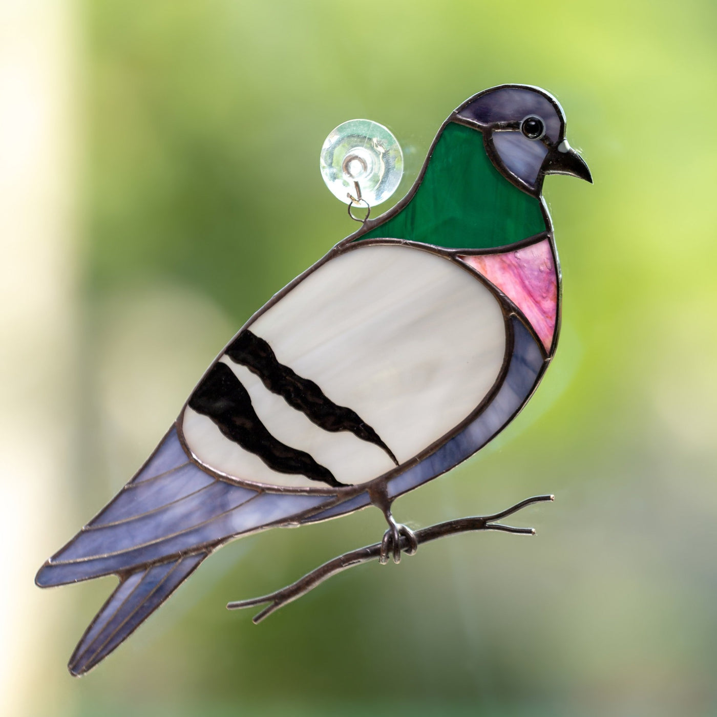 Colourful stained glass pigeon on the branch suncatcher