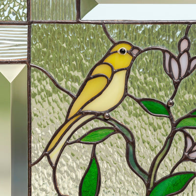 Zoomed stained glass canary bird on the lemon tree panel