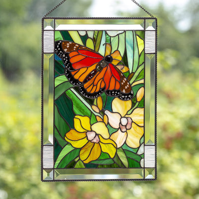 Stained glass panel depicting monarch butterfly with yellow orchids 
