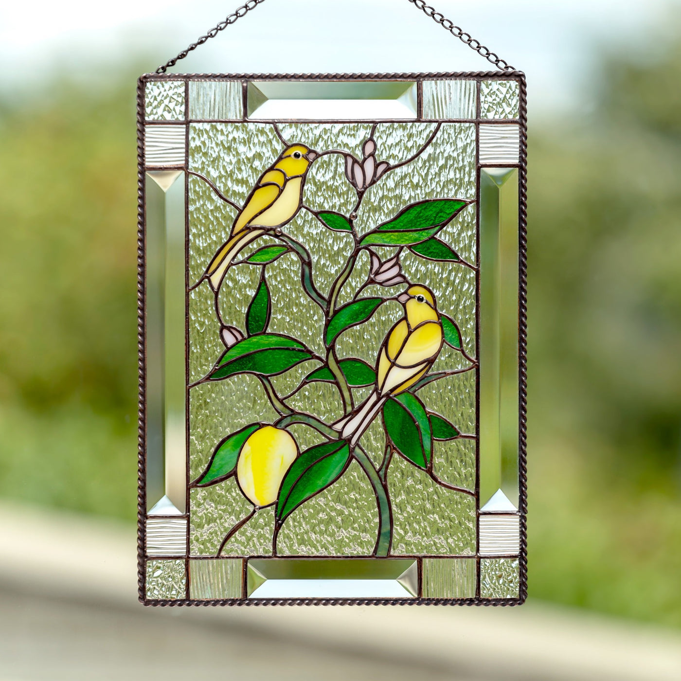 Stained glass canary birds sitting on the lemon tree panel 