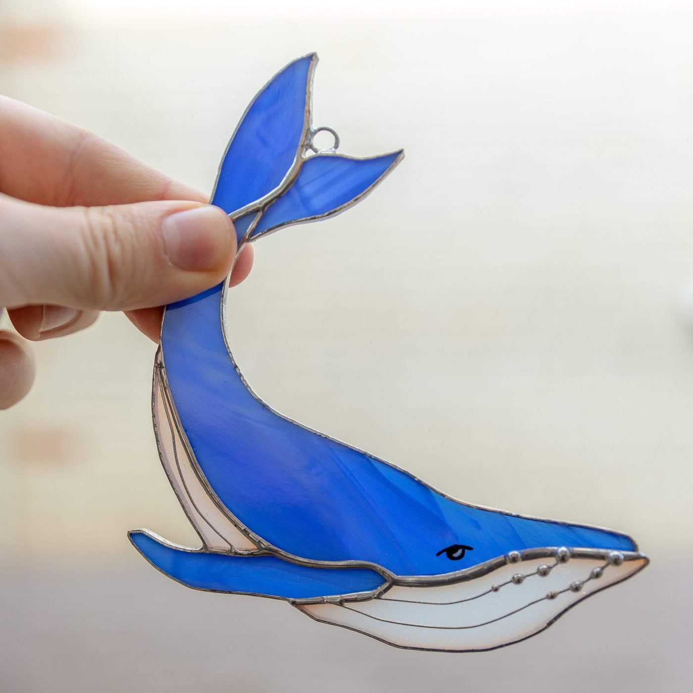 Royal blue stained glass whale with tail up suncatcher for window