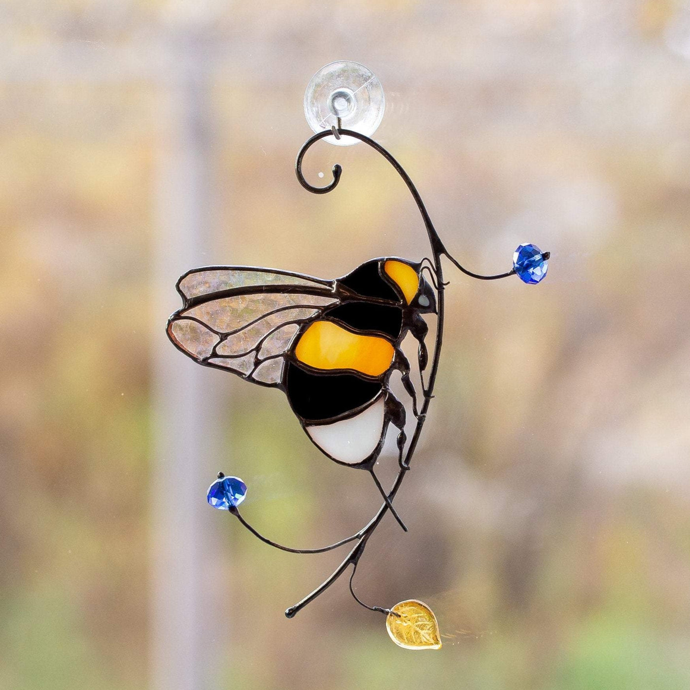 Clear-winged bumblebee sitting on the branch suncatcher