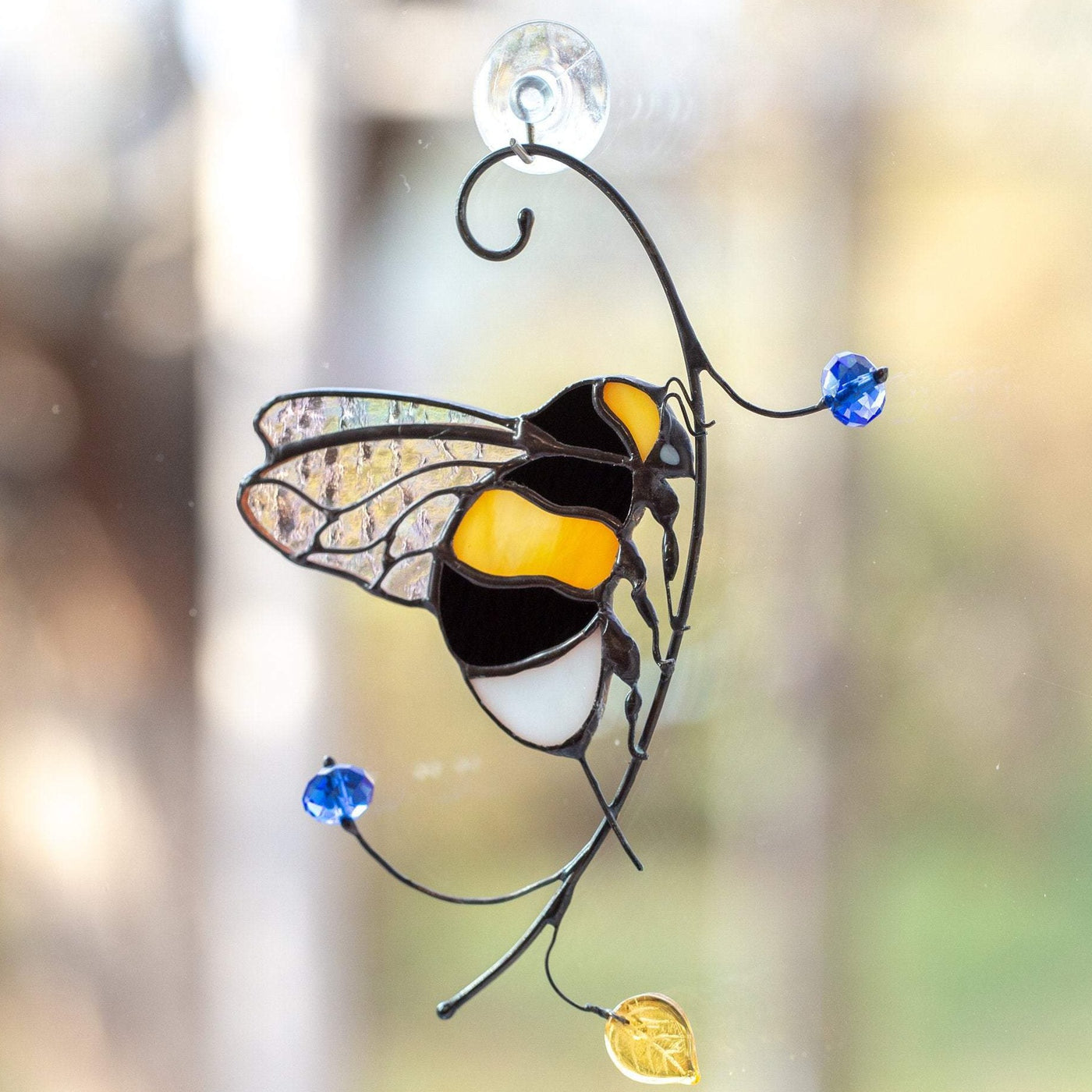 Stained glass suncatcher of a bumblebee with clear wings