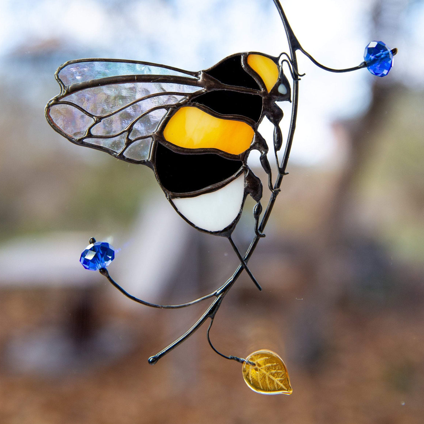 Stained glass sitting on the branch bumblebee window hanging