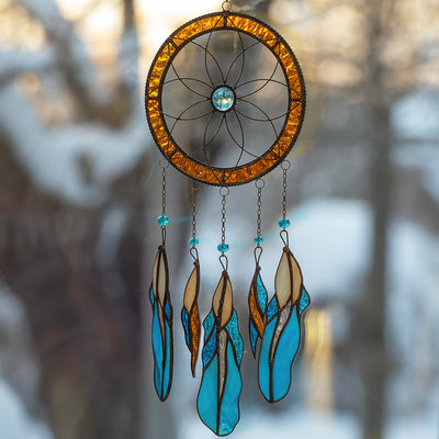 Flower-shaped stained glass dreamcatcher with hanging down blue feathers