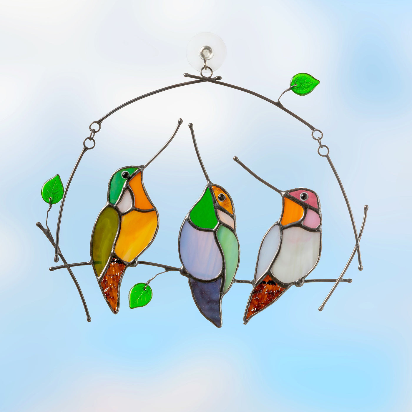 Three stained glass colourful hummingbirds sitting on the horizontal branch suncatcher
