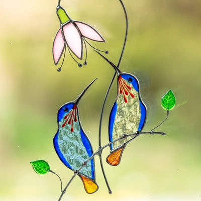 Zoomed stained glass blue hummingbirds on the branch suncatcher
