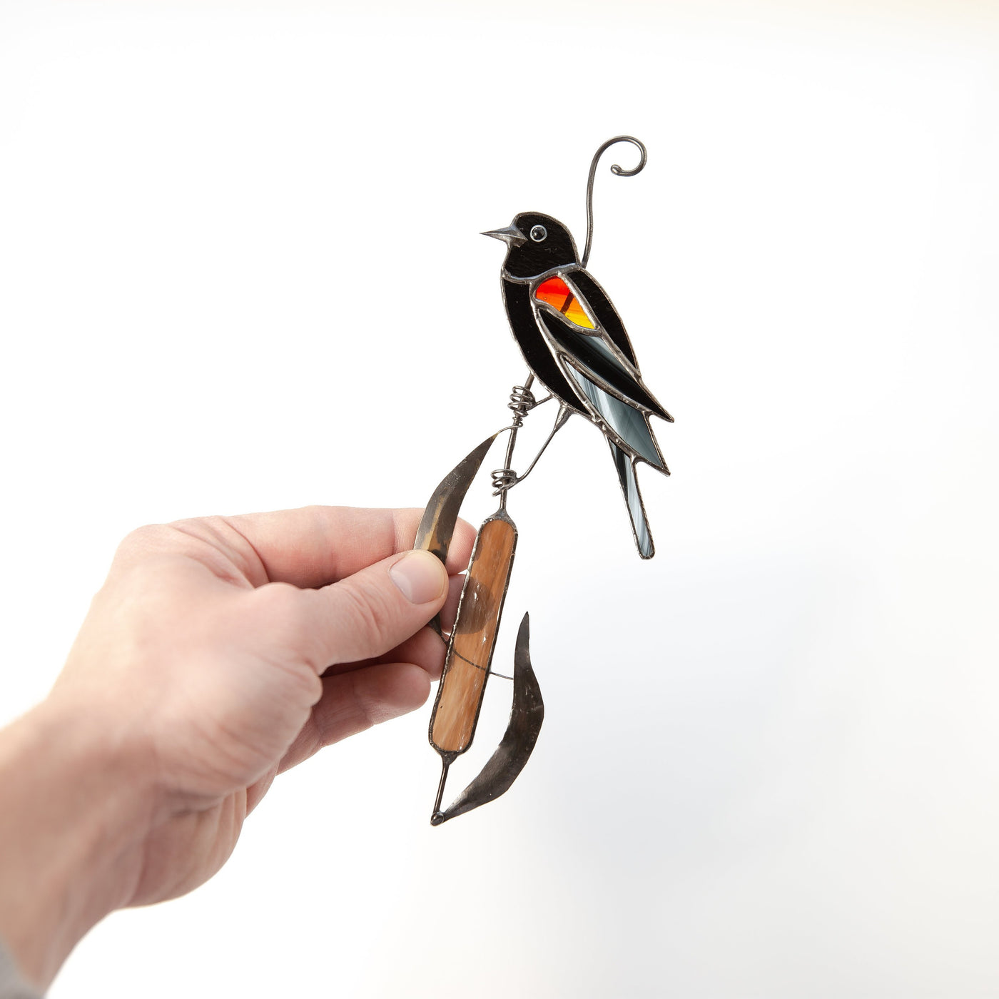Stained glass red-winged blackbird on the reeds suncatcher