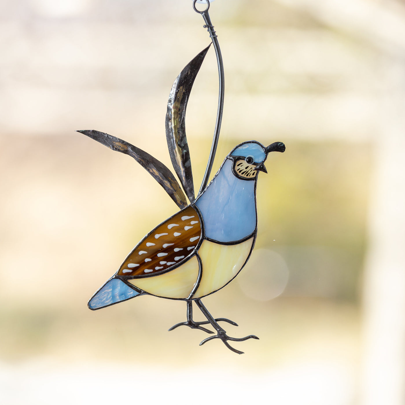 Female stained glass California quail suncatcher