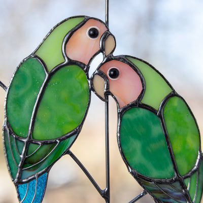 Zoomed stained glass lovebirds on the branch suncatcher