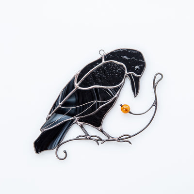 Sitting on the branch with berry stained glass raven window hanging