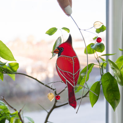 Red cardinal with golden spots window hanging of stained glass