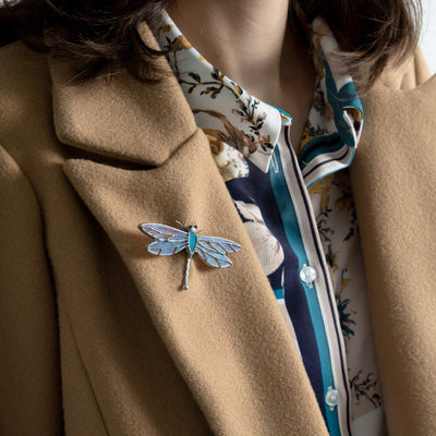 Dragonfly brooch on a camel coat