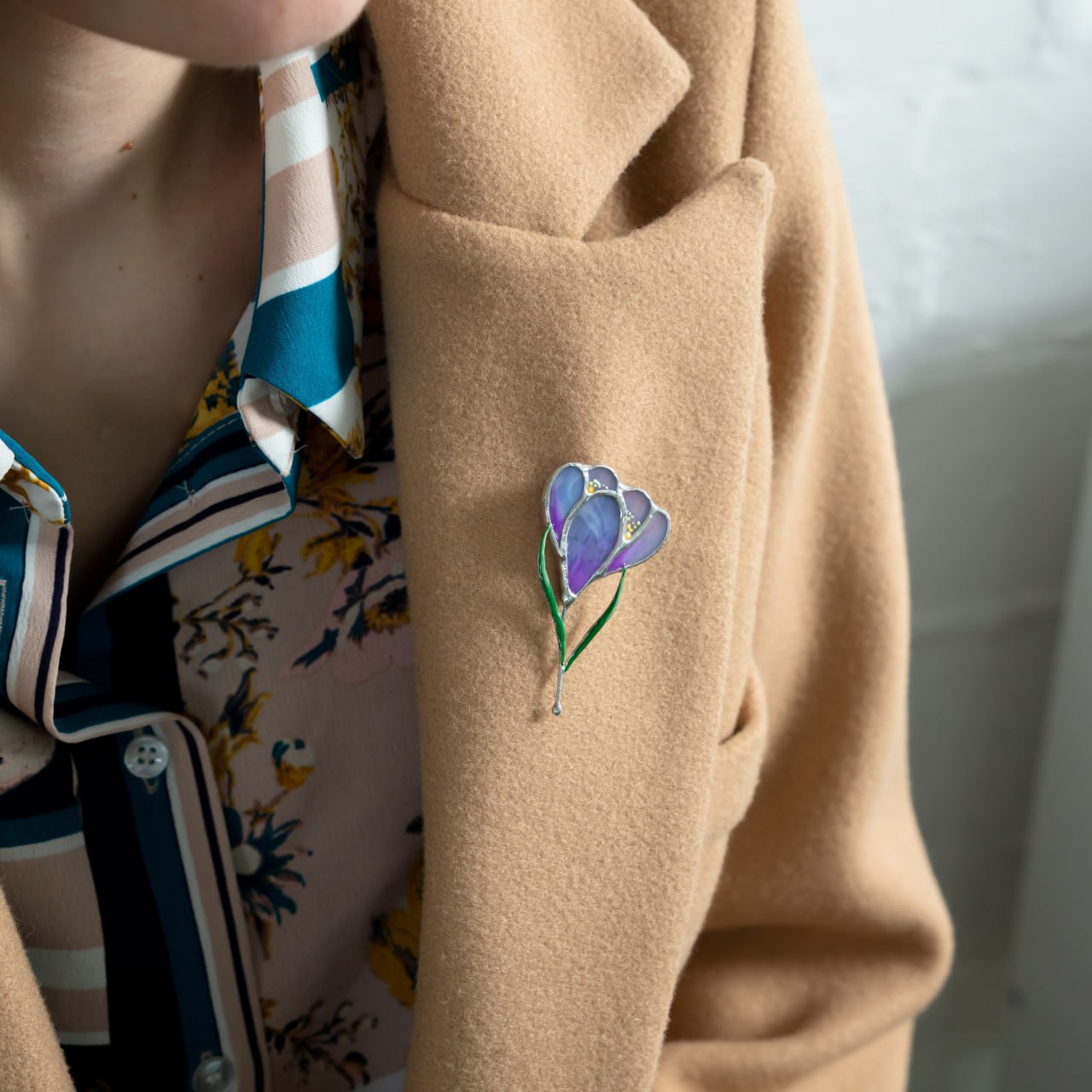 Purplish crocus flower brooch of stained glass in a camel coat